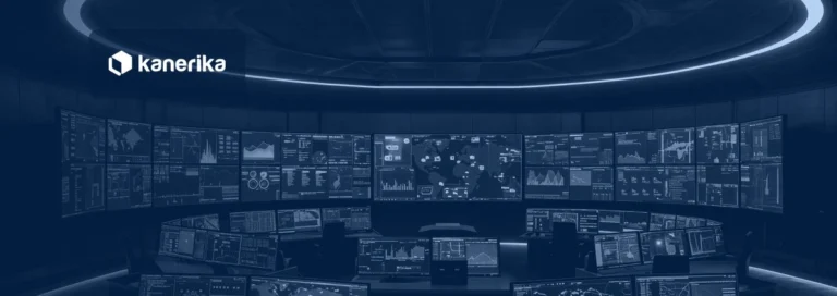 Dark command center with a wall of live data dashboards, representing real-time intelligence in Microsoft Fabric, shown in a navy blue tint with the Kanerika logo