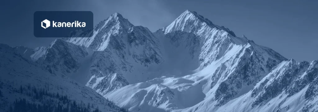 Snow-covered mountain peaks, a nod to the Snowflake data warehouse, shown in a navy blue tint with the Kanerika logo