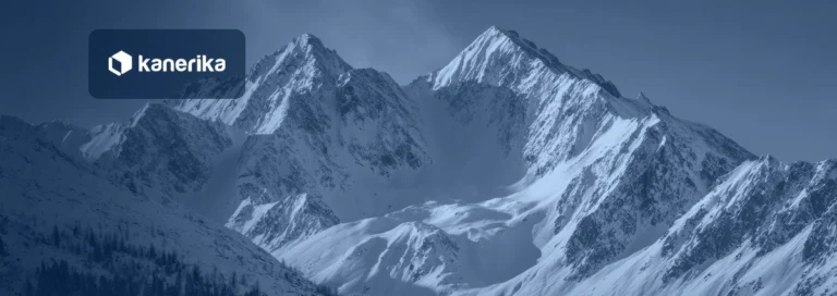 Snow-covered mountain peaks, a nod to the Snowflake data warehouse, shown in a navy blue tint with the Kanerika logo